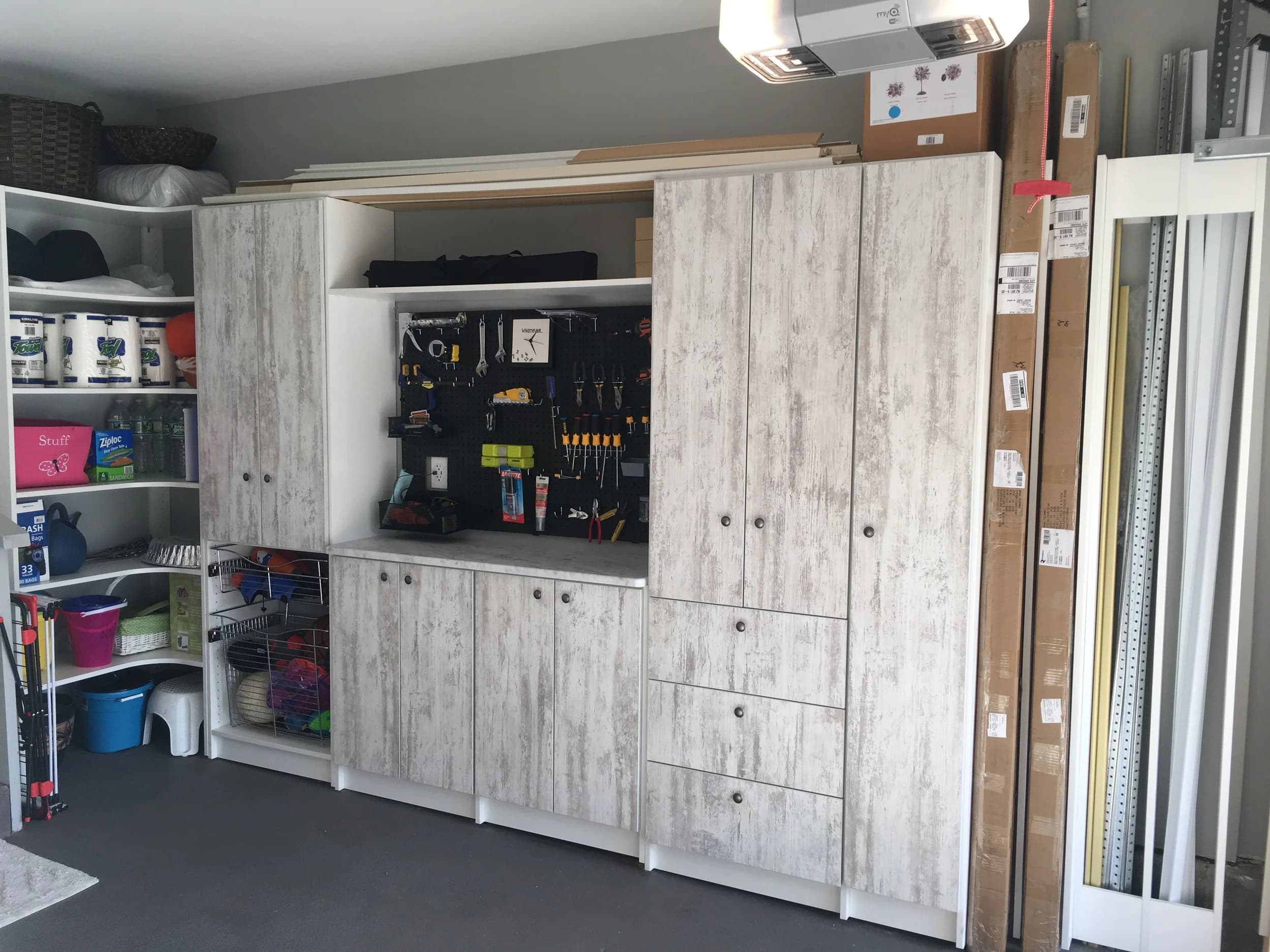 Garage cabinets with pegboard tool wall
