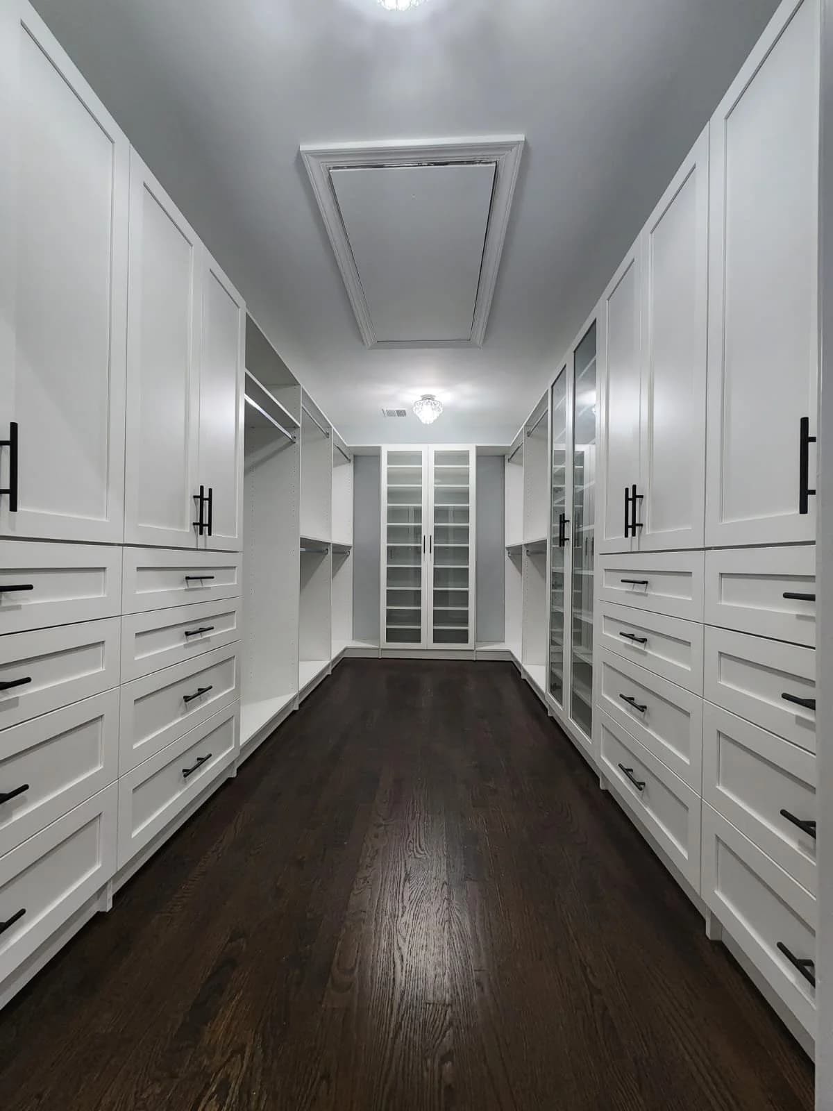 White walk-in closet with glass display cabinet