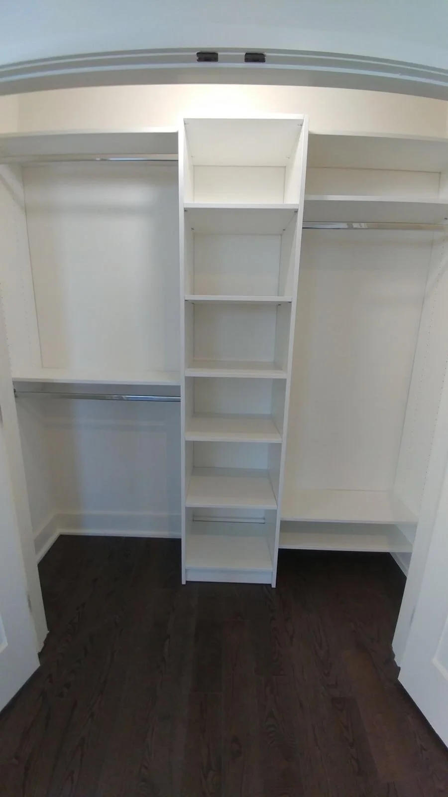 Classic wall-recessed reach-in closet with central tower