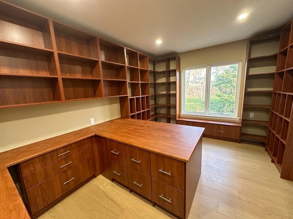 Wood-finish home office with desk and corner bookshelves