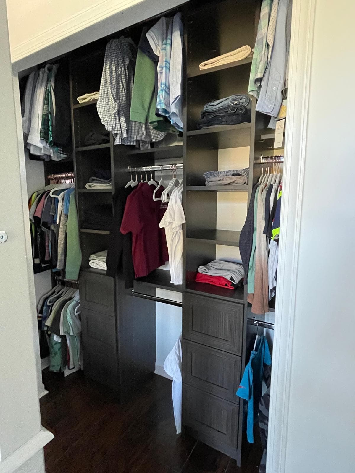 Dark espresso reach-in with central tower, drawers, and full-length hanging